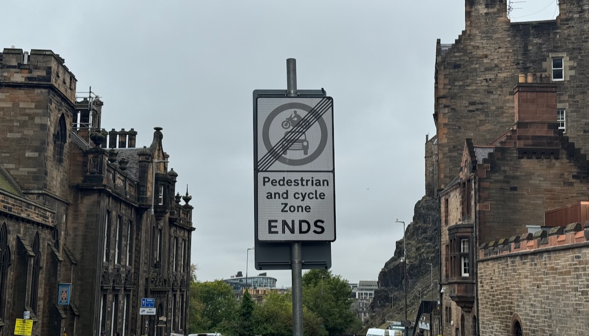 A street sign reads 'pedestrian and cycle zone ends'
